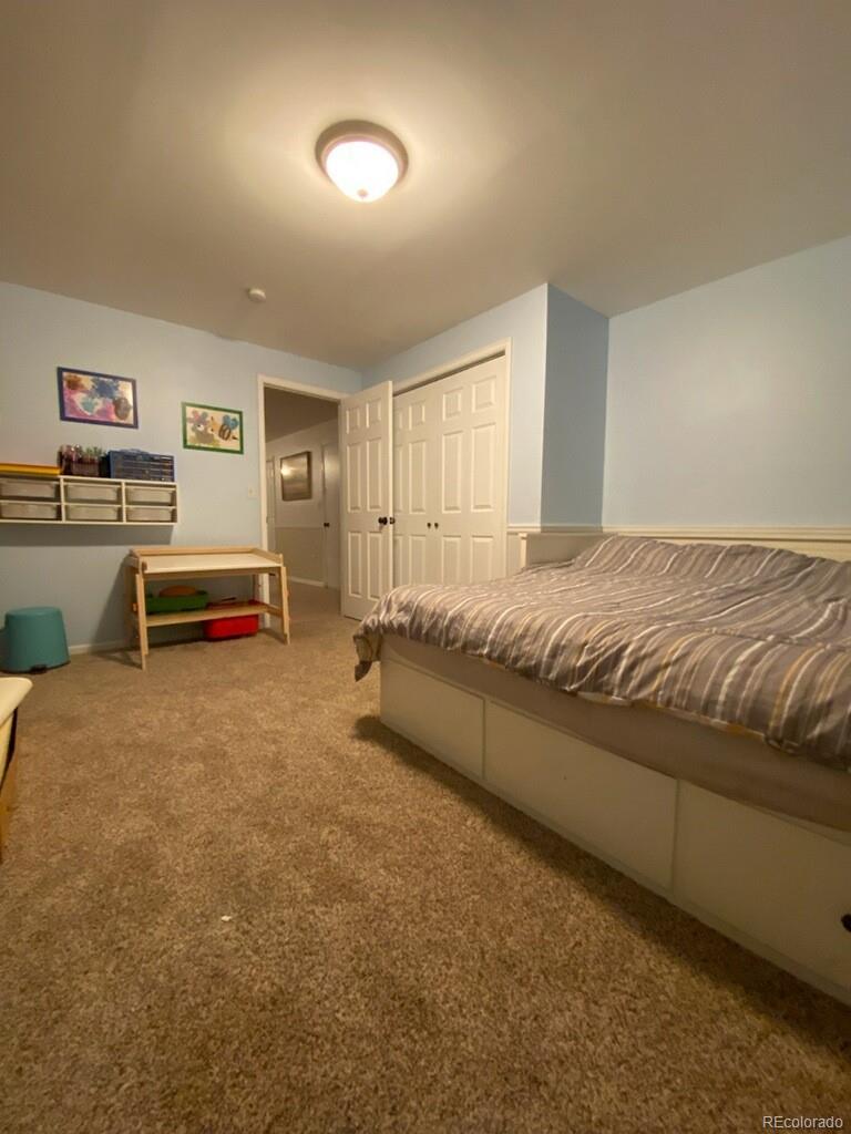 6359 Powell Road Parker, CO 80134 - Photo 29 of 38 a spacious bedroom with a bed and furniture