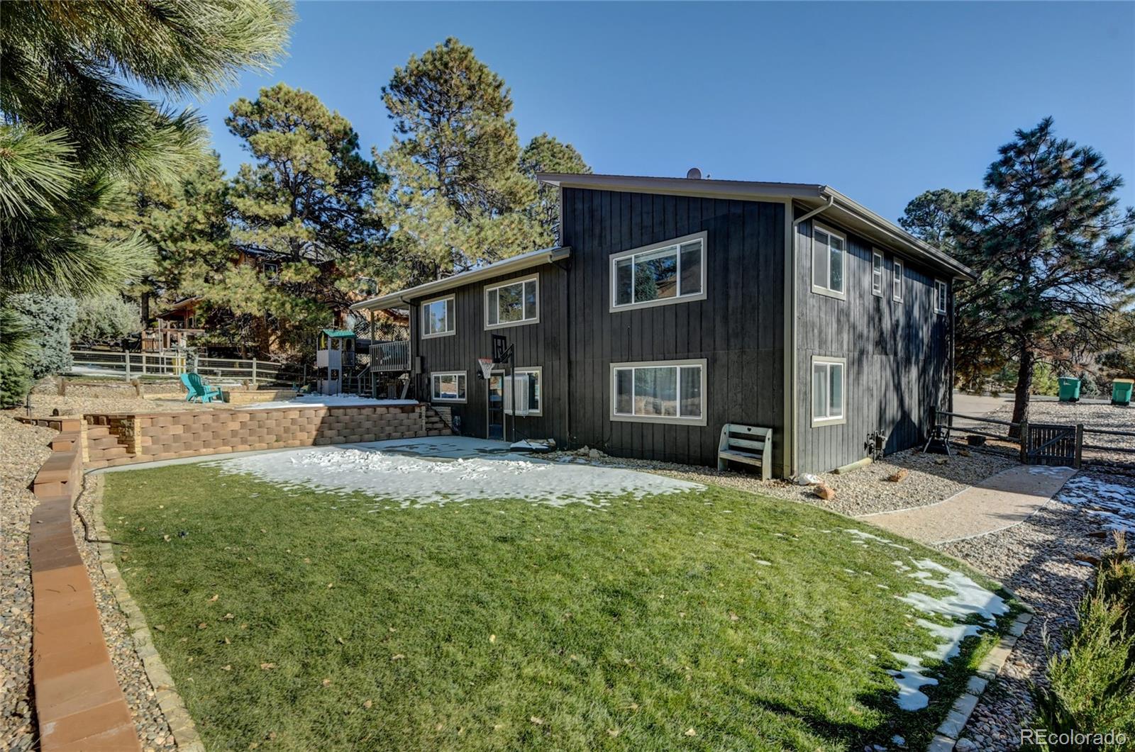 6359 Powell Road Parker, CO 80134 - Photo 31 of 38 a view of a house with a yard