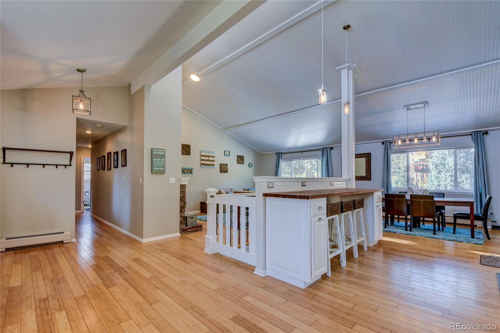 6359 Powell Road Parker, CO 80134 - Photo 8 of 38 a large kitchen with lots of counter space and wooden floor