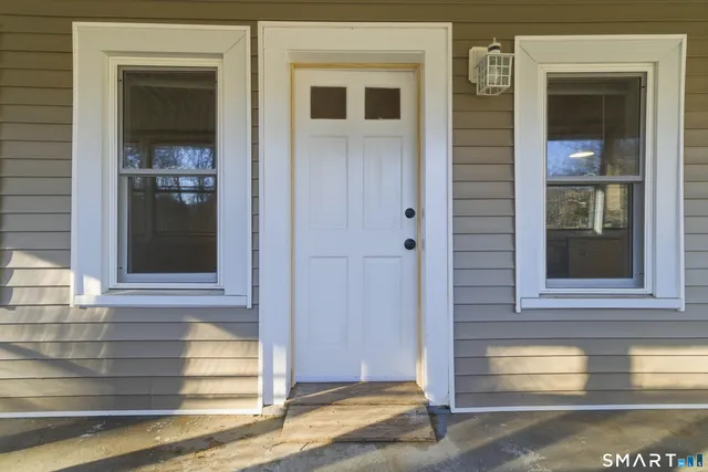 front view of a brick house with a large windows