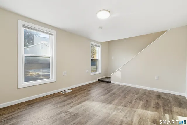 an empty room with windows and closet