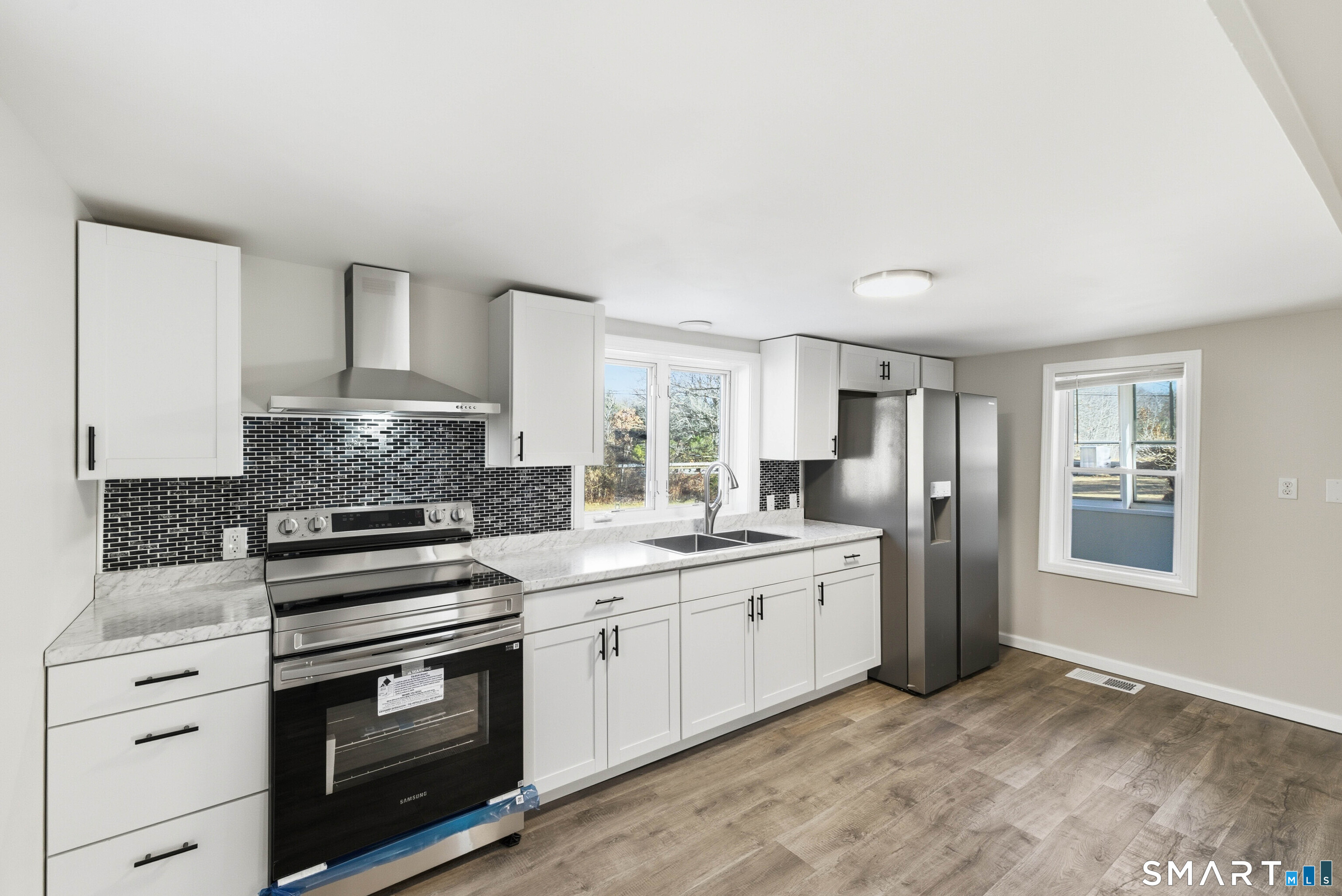 40 Tarbox Road Plainfield, CT 06374 - Photo 29 of 33 a kitchen with white cabinets stainless steel appliances and sink