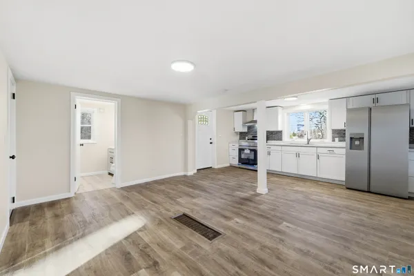 a kitchen with a refrigerator and a stove top oven