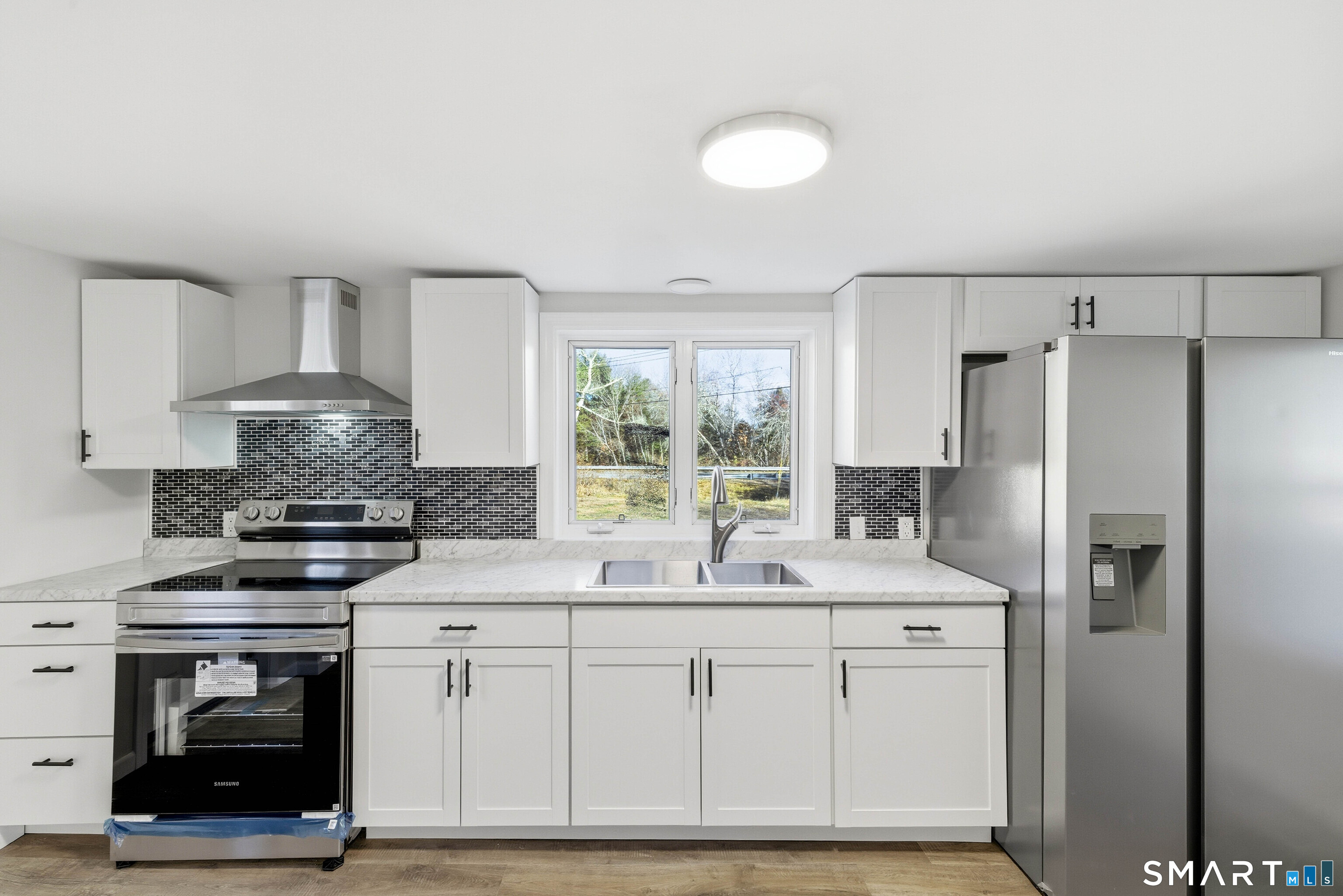 40 Tarbox Road Plainfield, CT 06374 - Photo 8 of 33 a kitchen with kitchen island granite countertop a stove a sink and a refrigerator