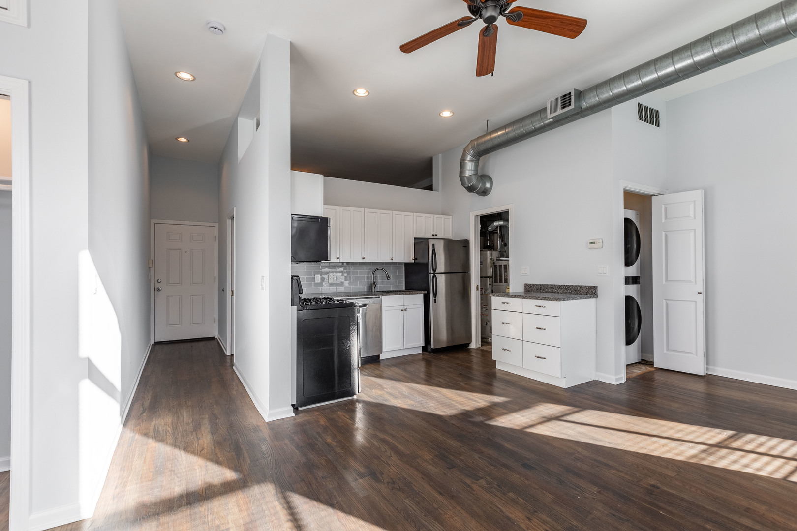 1133 West Madison Street, Unit 2R Chicago, IL 60607 - Photo 2 of 15 a view of a kitchen with a sink wooden floor and a ceiling fan