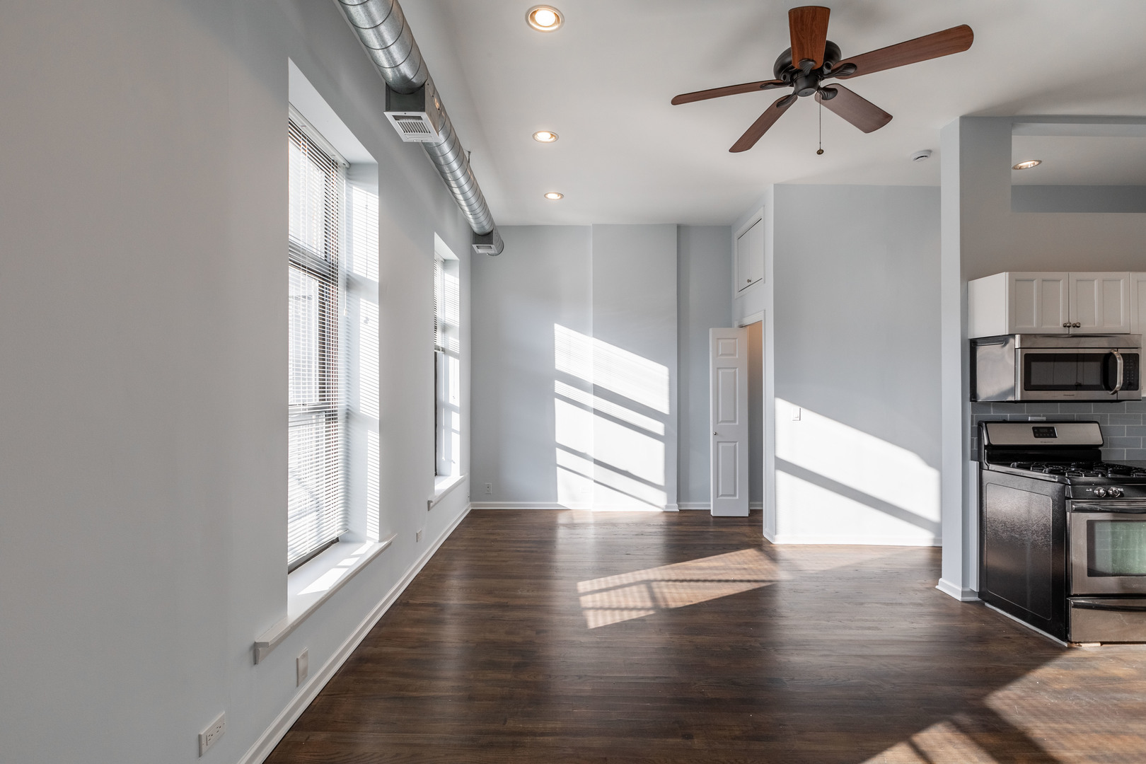 1133 West Madison Street, Unit 2R Chicago, IL 60607 - Photo 10 of 15 a view of hallway with wooden floor and window