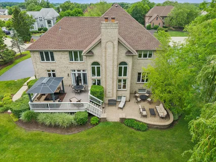 an aerial view of a house with swimming pool patio and outdoor seating