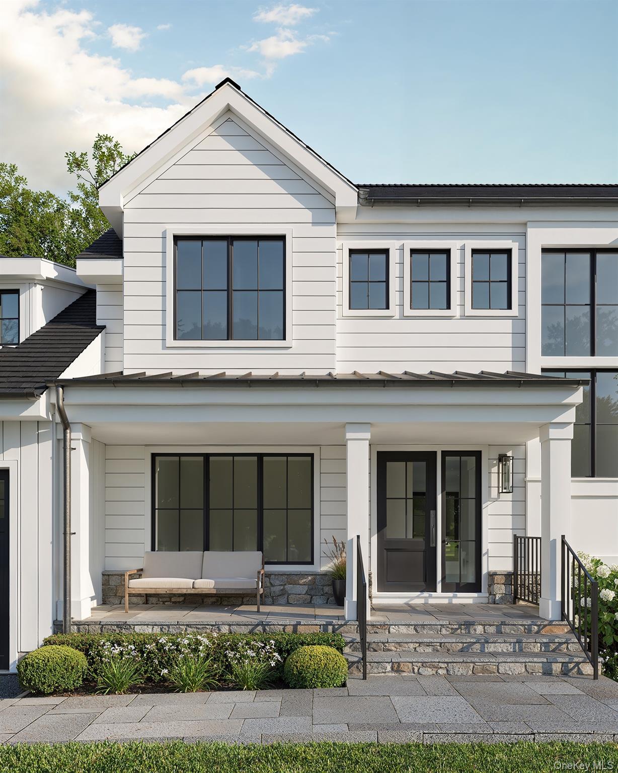 28 Everett Street Rye, NY 10580 - Photo 2 of 21 a front view of a house with garden and garage