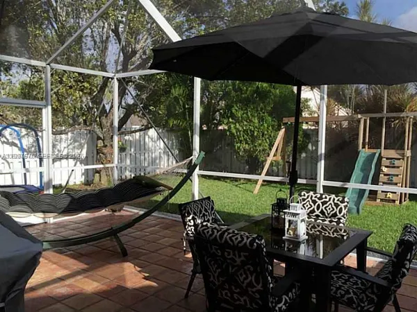 a view of a chairs and table in the patio