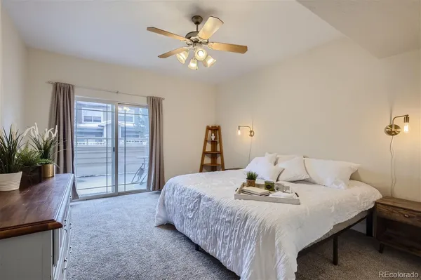 a bedroom with a bed and a potted plant