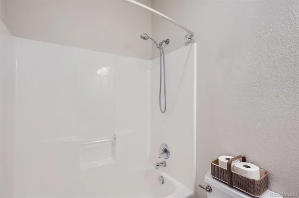 a bathroom with a bath tub with a shower