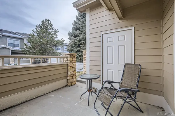 a view of a patio with table and chairs and wooden floor