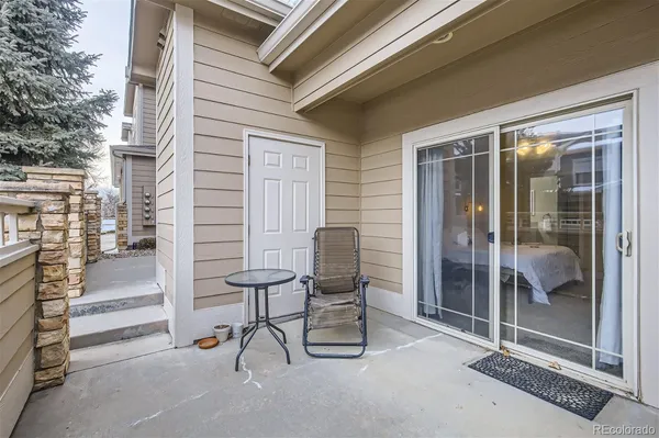 a view of a patio with chair and tables