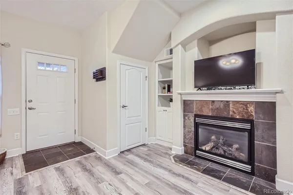 a living room with a fireplace and a flat screen tv
