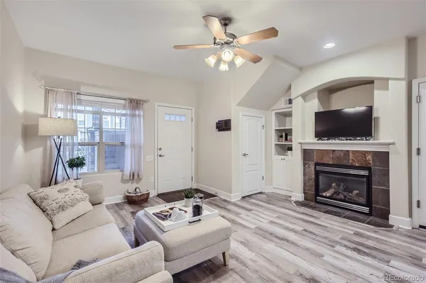 a living room with furniture a fireplace and a flat screen tv