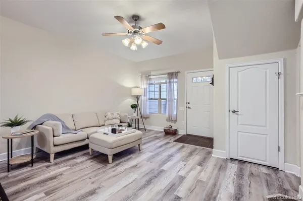 a living room with furniture and wooden floor