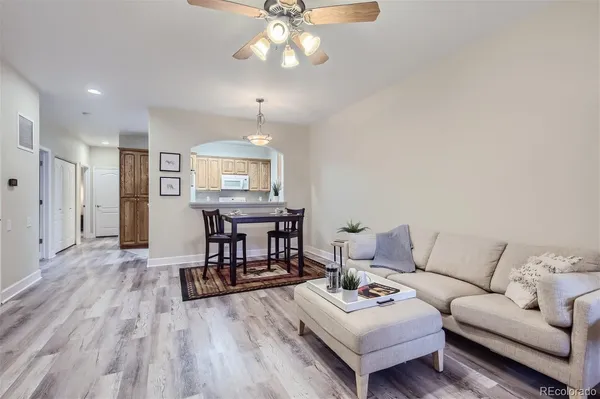 a living room with furniture and a wooden floor