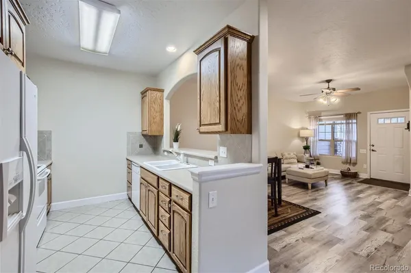 a kitchen with a sink stove and wooden cabinets