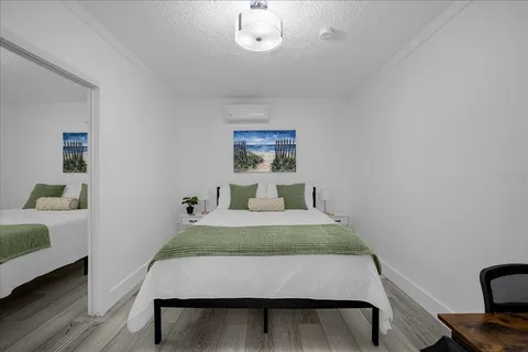 a bed room with a bed and a large window
