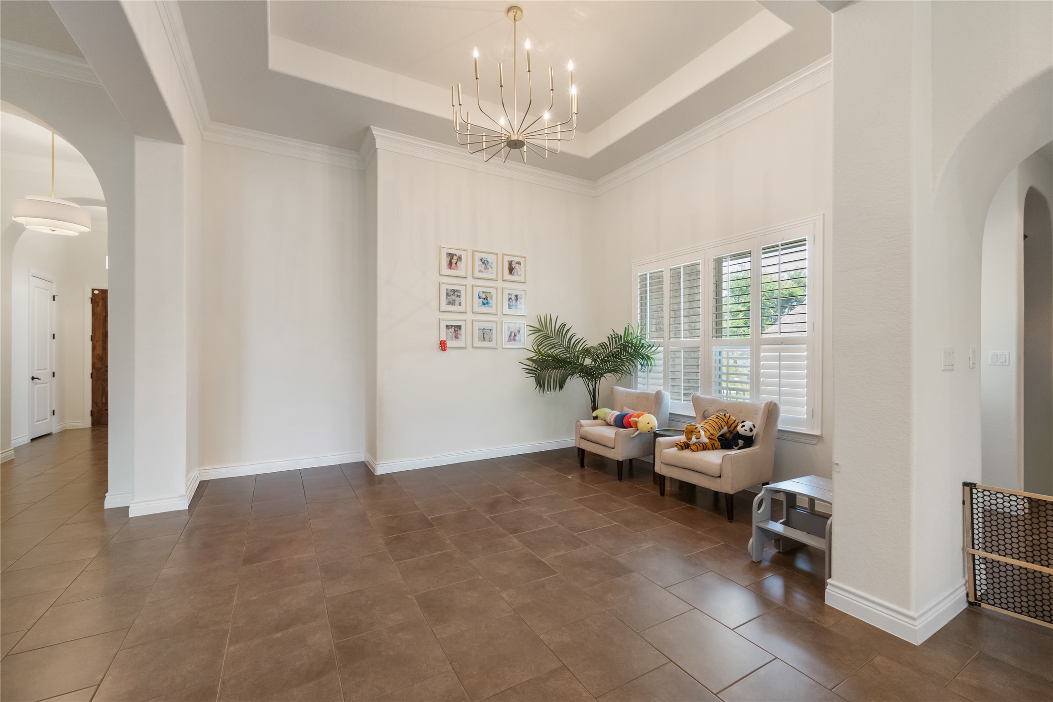415 Bitterroot Lane Austin, TX 78737 - Photo 10 of 25 A welcoming entryway boasts high ceilings, elegant crown molding, and tiled flooring.