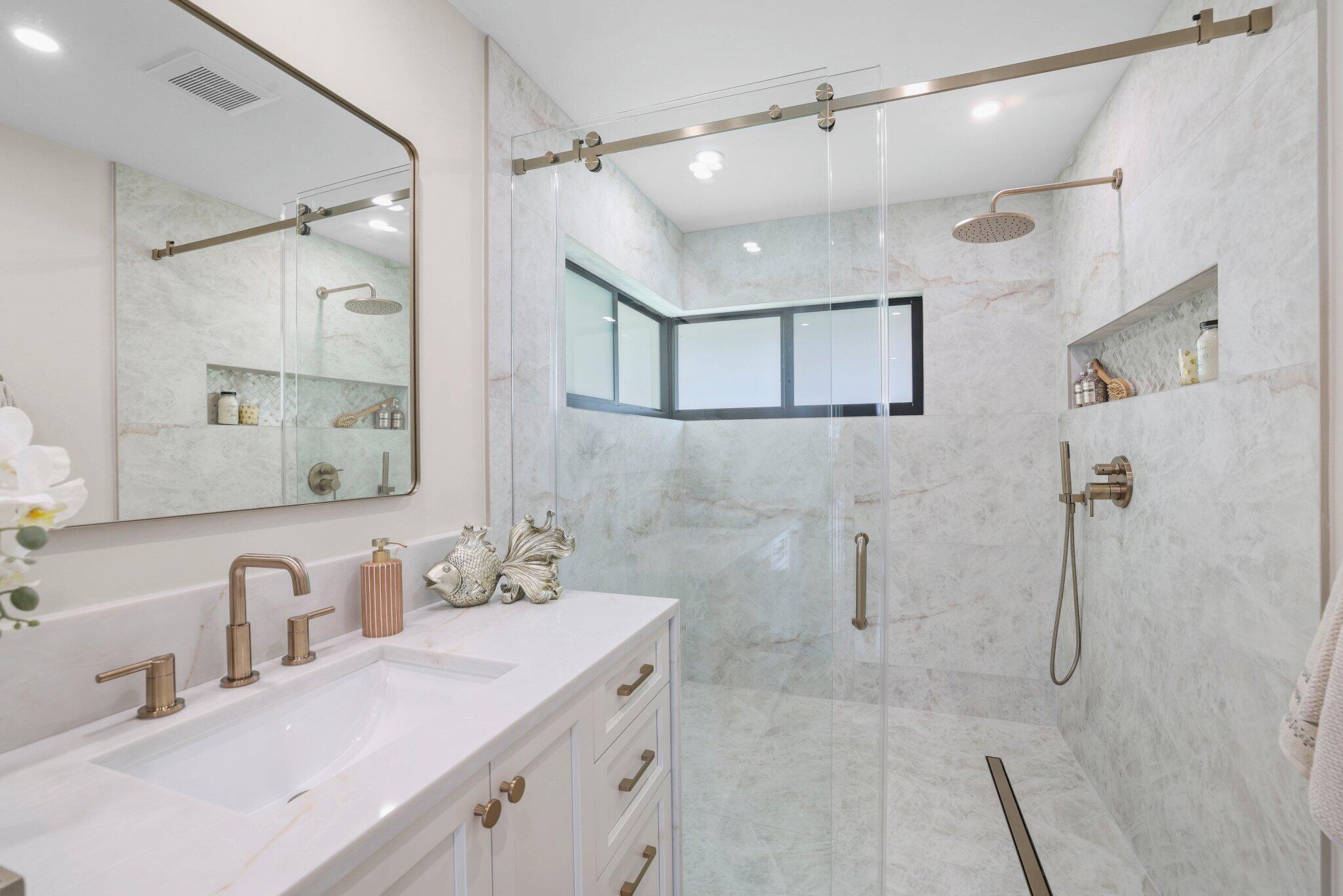 3901 Northwest 27th Avenue Boca Raton, FL 33434 - Photo 38 of 56 a bathroom with a double vanity sink mirror and shower