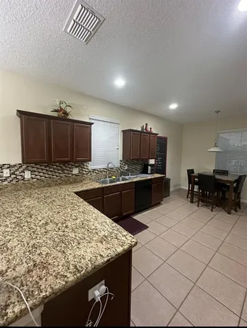 a kitchen with sink and cabinets