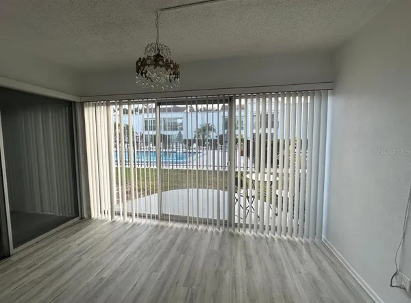 a view of a room with wooden floor