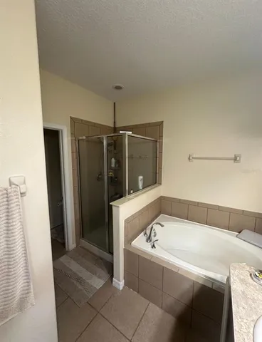 a bathroom with a bathtub and shower