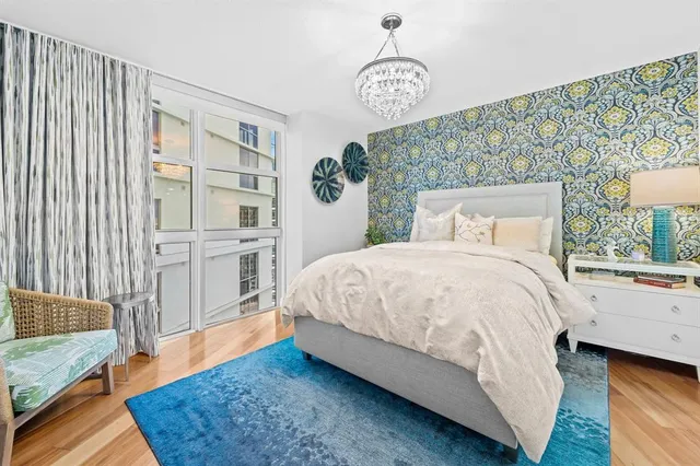 a spacious bedroom with a bed and a window