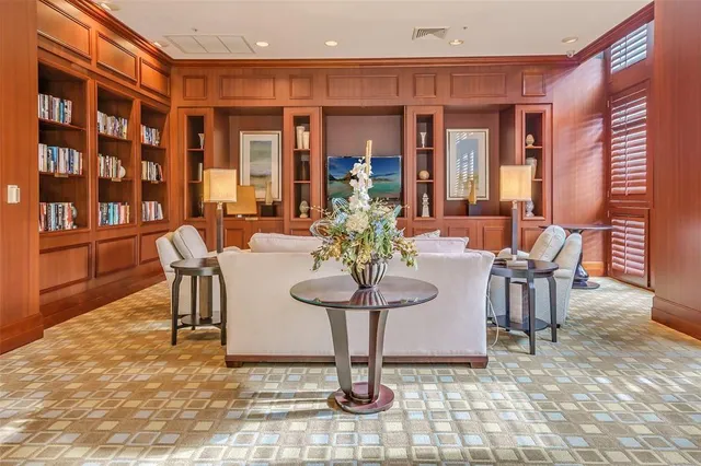 a view of a dining room with furniture and a chandelier
