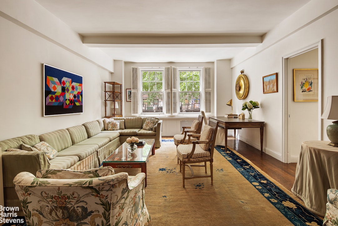 a living room with furniture large window and a flat screen tv