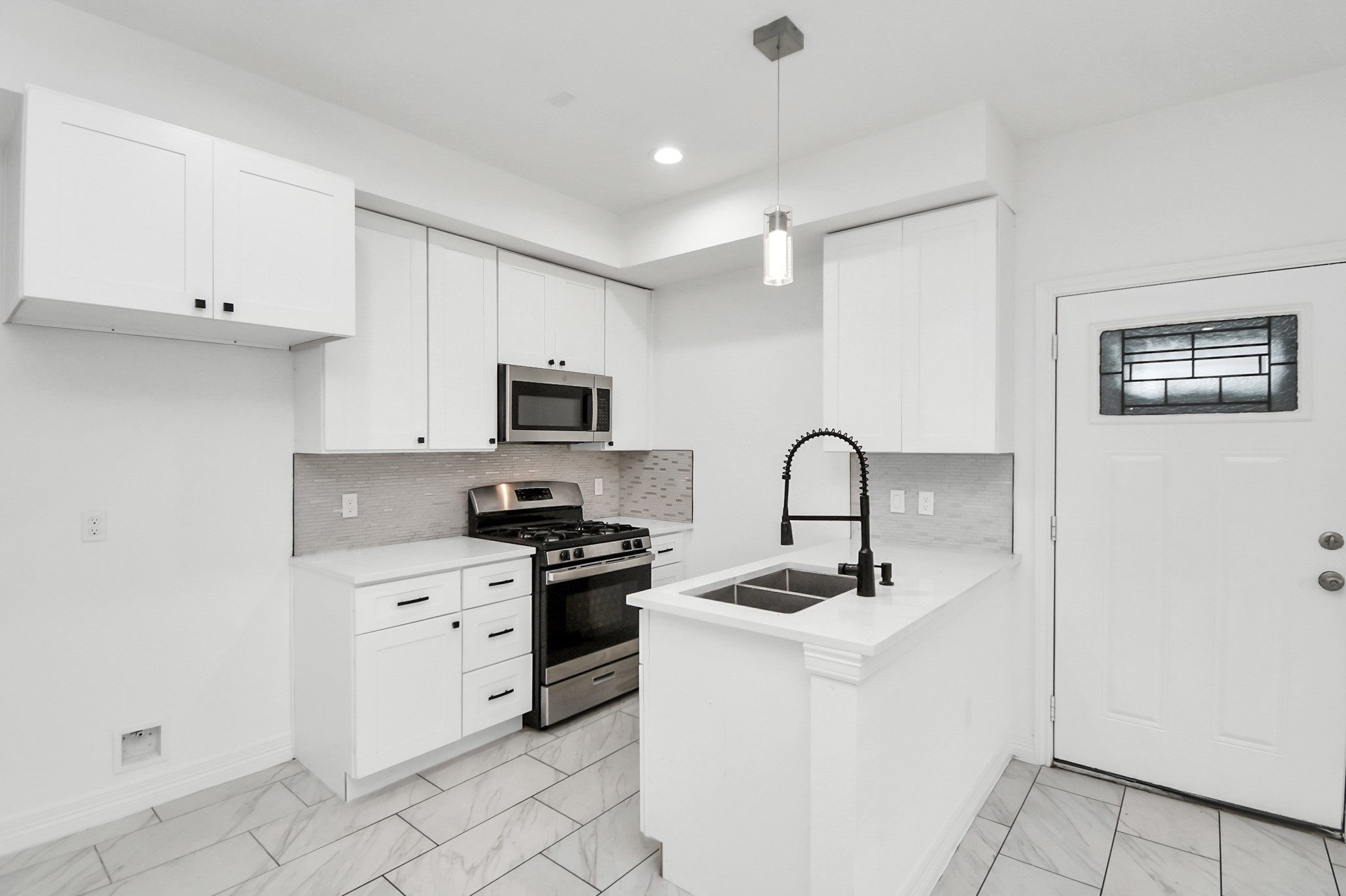 9003 Prairie View Drive, Unit B Houston, TX 77088 - Photo 10 of 20 a kitchen with white cabinets stainless steel appliances and sink
