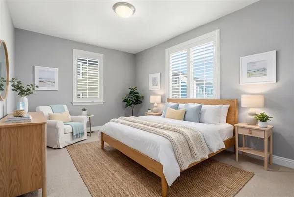 a bedroom with a bed and windows