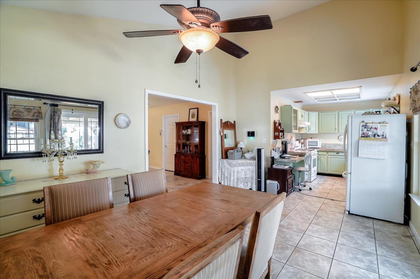 781 5th Street Gilroy, CA 95020 - Photo 14 of 33 a large kitchen with a table chairs refrigerator and cabinets