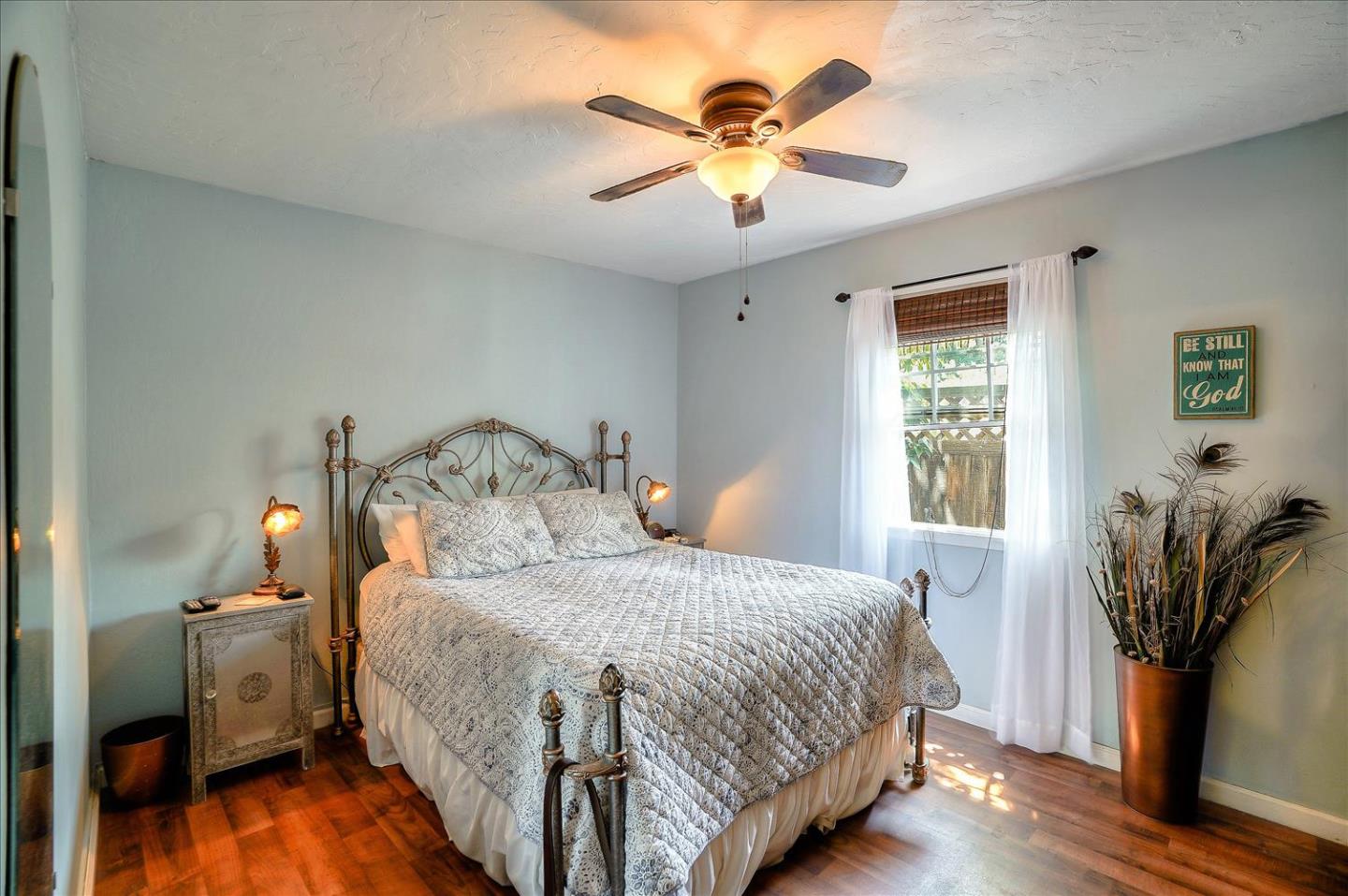 781 5th Street Gilroy, CA 95020 - Photo 19 of 33 a bedroom with a bed and a chandelier