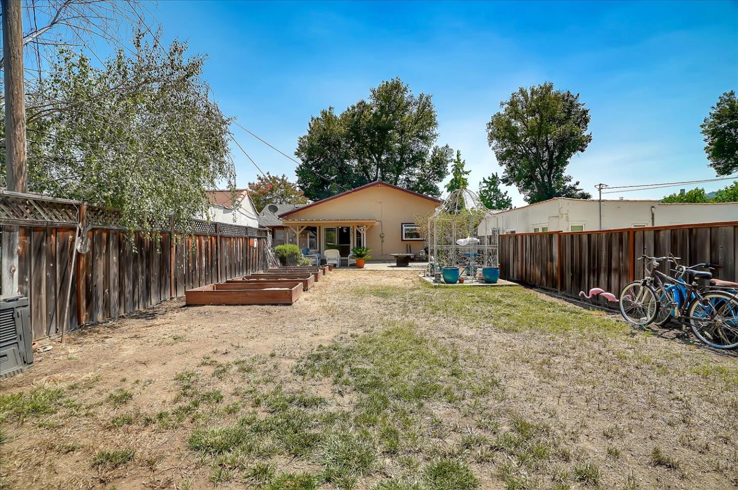 781 5th Street Gilroy, CA 95020 - Photo 24 of 33 a white house with a large tree and wooden fence