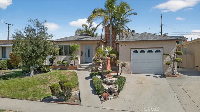 a front view of a house with garden