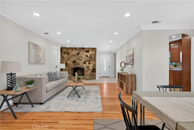 a living room with furniture a table and a fireplace