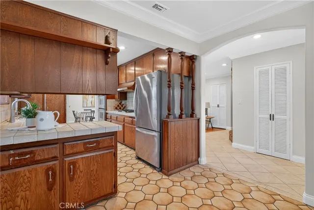 a kitchen with stainless steel appliances a refrigerator and a sink