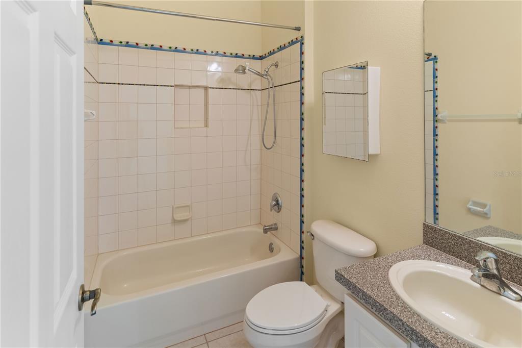 2718 Knightsbridge Road Clermont, FL 34711 - Photo 21 of 32 a bathroom with a granite countertop bathtub shower sink vanity and toilet