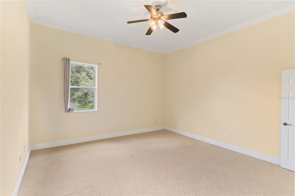 2718 Knightsbridge Road Clermont, FL 34711 - Photo 22 of 32 an empty room with a window and a fan