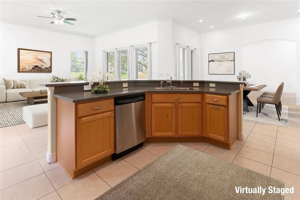 2718 Knightsbridge Road Clermont, FL 34711 - Photo 4 of 32 a kitchen with stainless steel appliances granite countertop a sink and cabinets