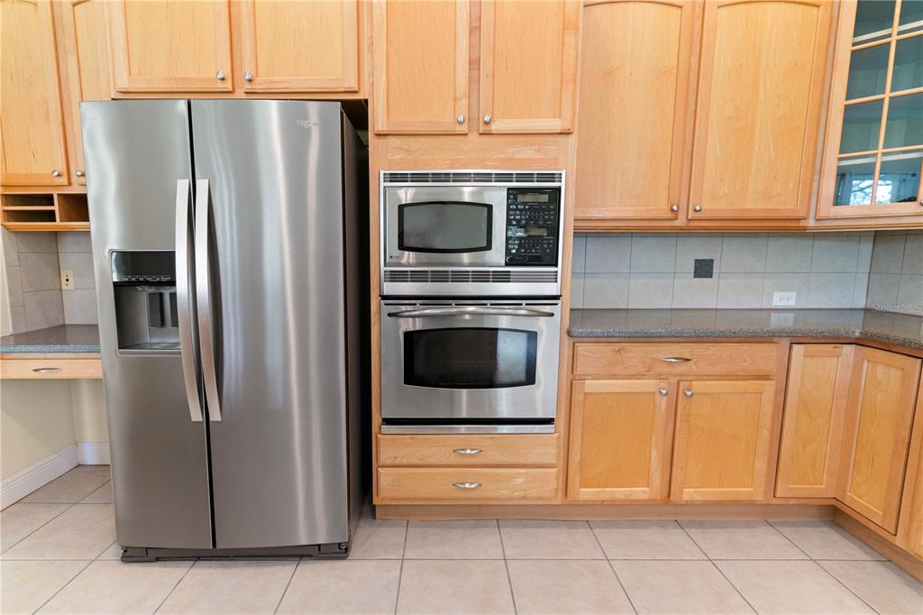 2718 Knightsbridge Road Clermont, FL 34711 - Photo 5 of 32 a kitchen with stainless steel appliances granite countertop a refrigerator and a stove top oven