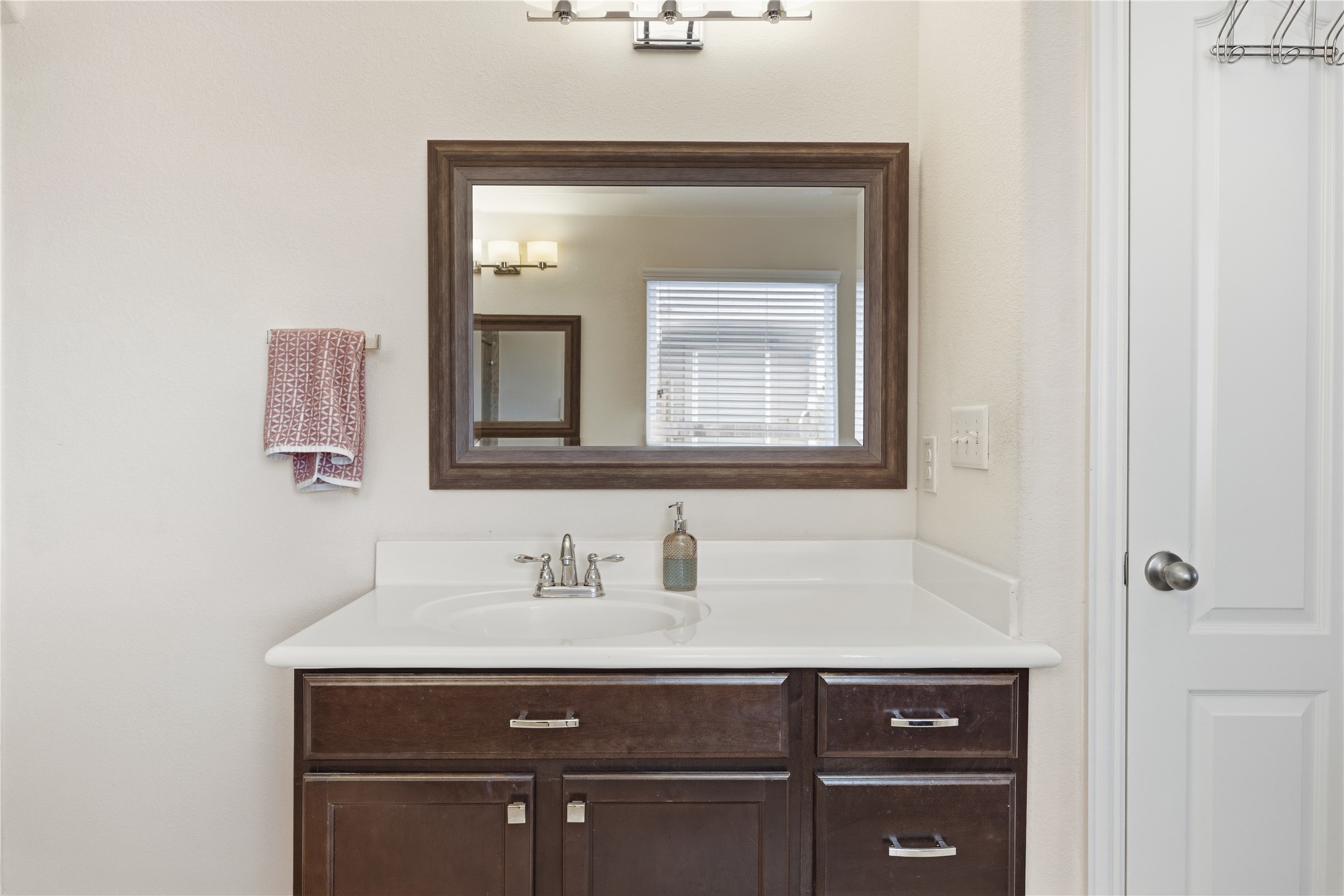 486 Pond View Pass Buda, TX 78610 - Photo 32 of 39 Bathroom featuring a dark wood-finish vanity with a white countertop and integrated sink