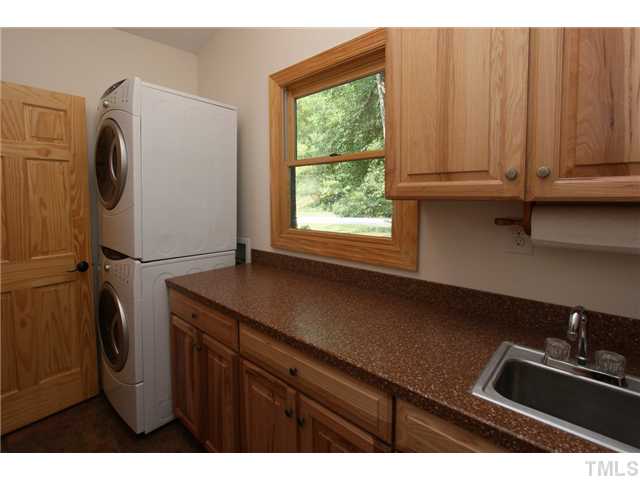6248 Rushingbrook Drive Raleigh, NC 27612 - Photo 14 of 25 a kitchen with a refrigerator and a sink