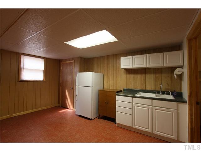6248 Rushingbrook Drive Raleigh, NC 27612 - Photo 19 of 25 a kitchen with a refrigerator and a sink