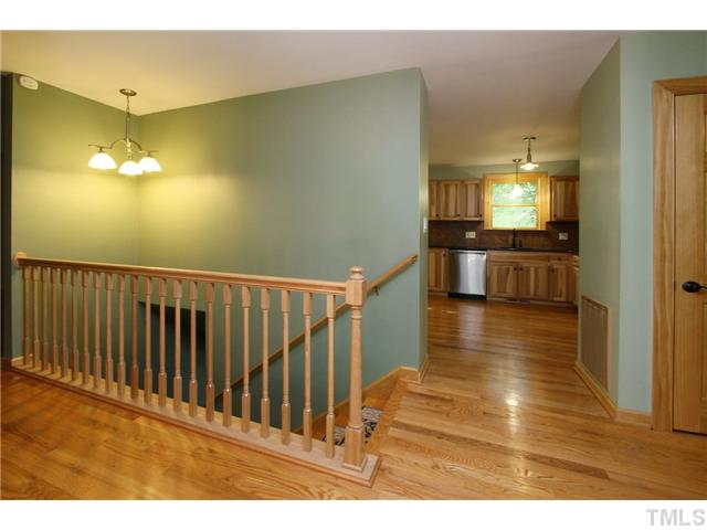 6248 Rushingbrook Drive Raleigh, NC 27612 - Photo 2 of 25 a view of a livingroom with kitchen and an entryway