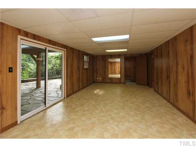 6248 Rushingbrook Drive Raleigh, NC 27612 - Photo 21 of 25 a view of an empty room with windows