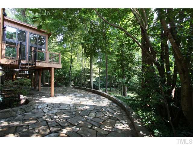 6248 Rushingbrook Drive Raleigh, NC 27612 - Photo 23 of 25 a backyard of a house with table and chairs