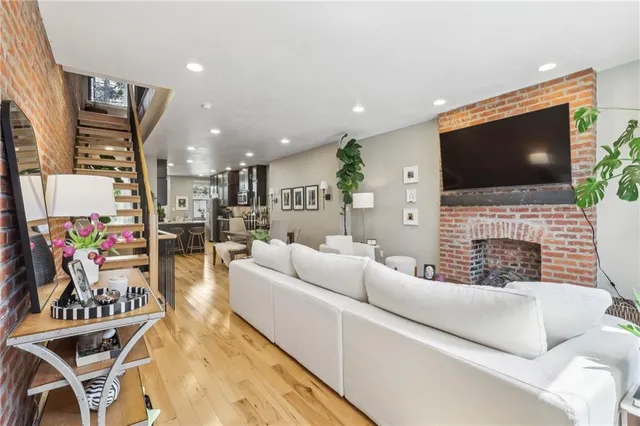 a living room with fireplace furniture and a flat screen tv